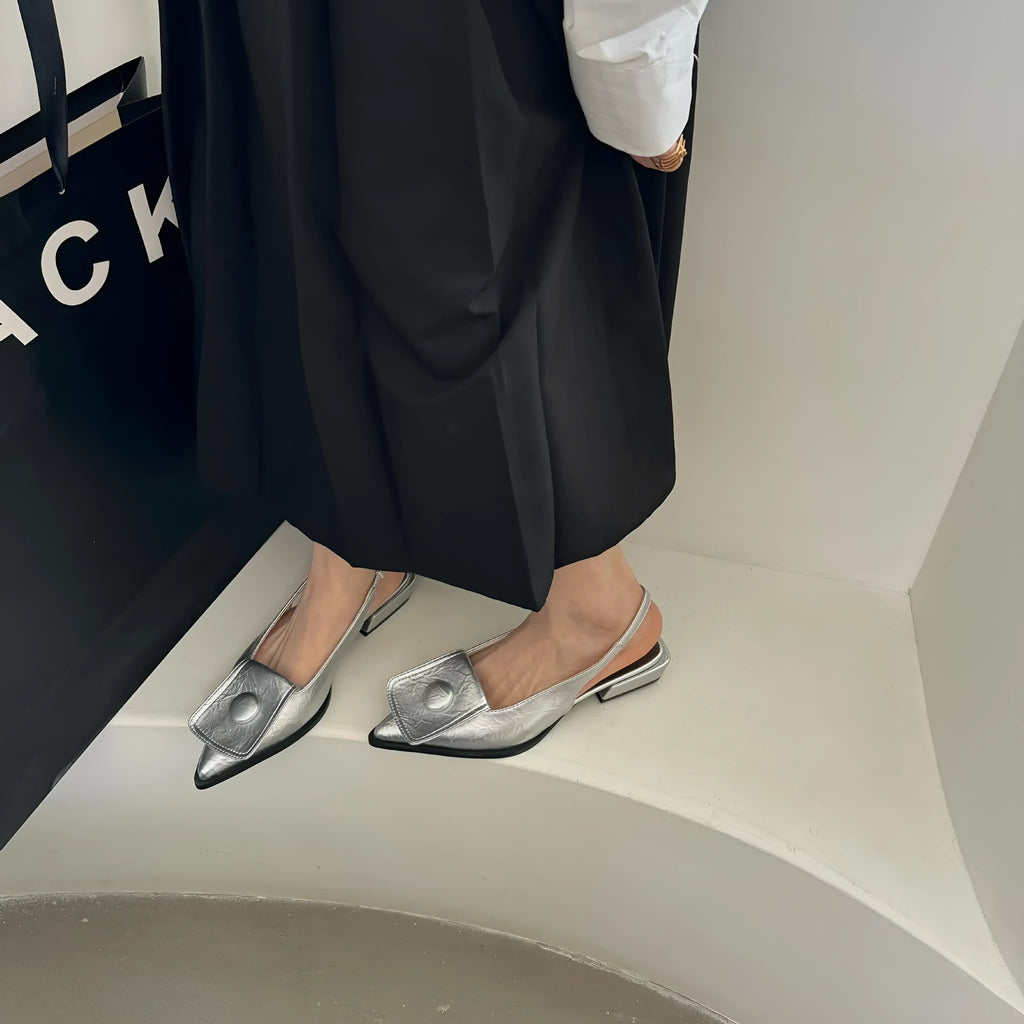 Women's low heel closed toe sandals in apricot with a pointed toe and back strap.