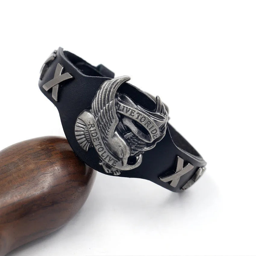 Black leather geometric bracelet with eagle watch button, showing tapered width.
