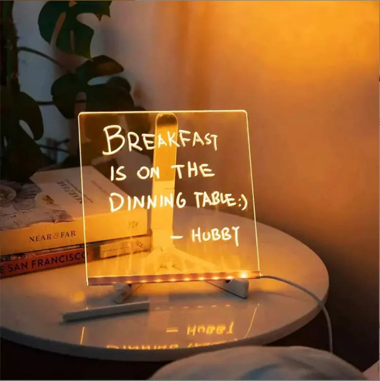 Acrylic DIY note board LED night light with USB cable, bracket, and colourful pens on a desk