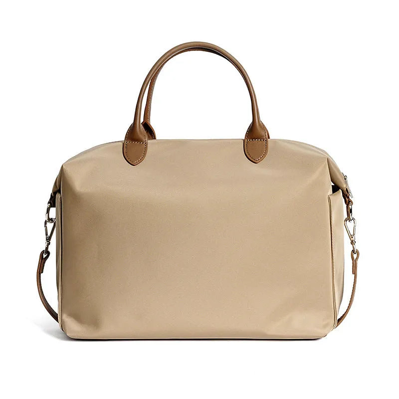 Nylon waterproof shoulder bag in black or light khaki measuring 35cm wide with leather accents
