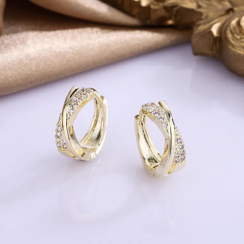 Geometric shape copper earrings with zircon accents in 14K yellow gold tone.