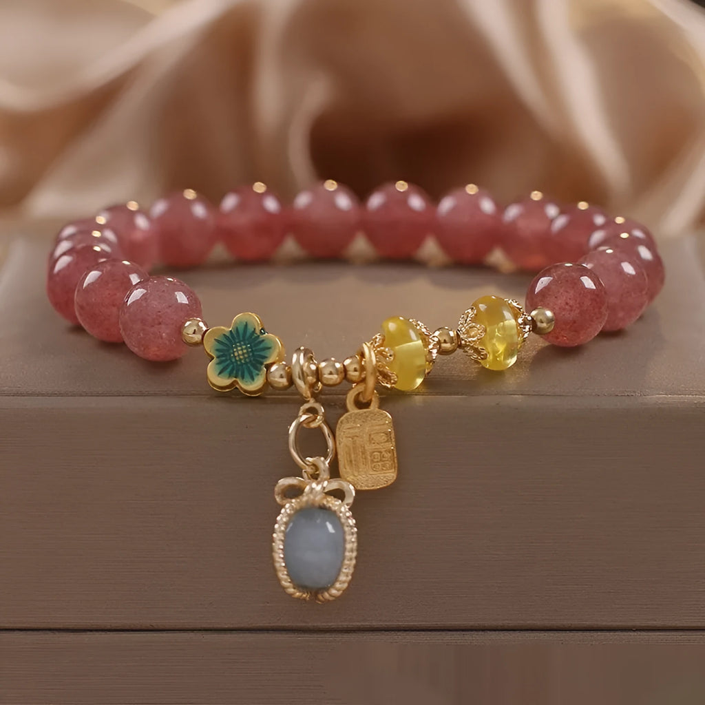 Red women's bracelet with natural strawberry quartz beads, alloy settings, and rhinestone decorative elements