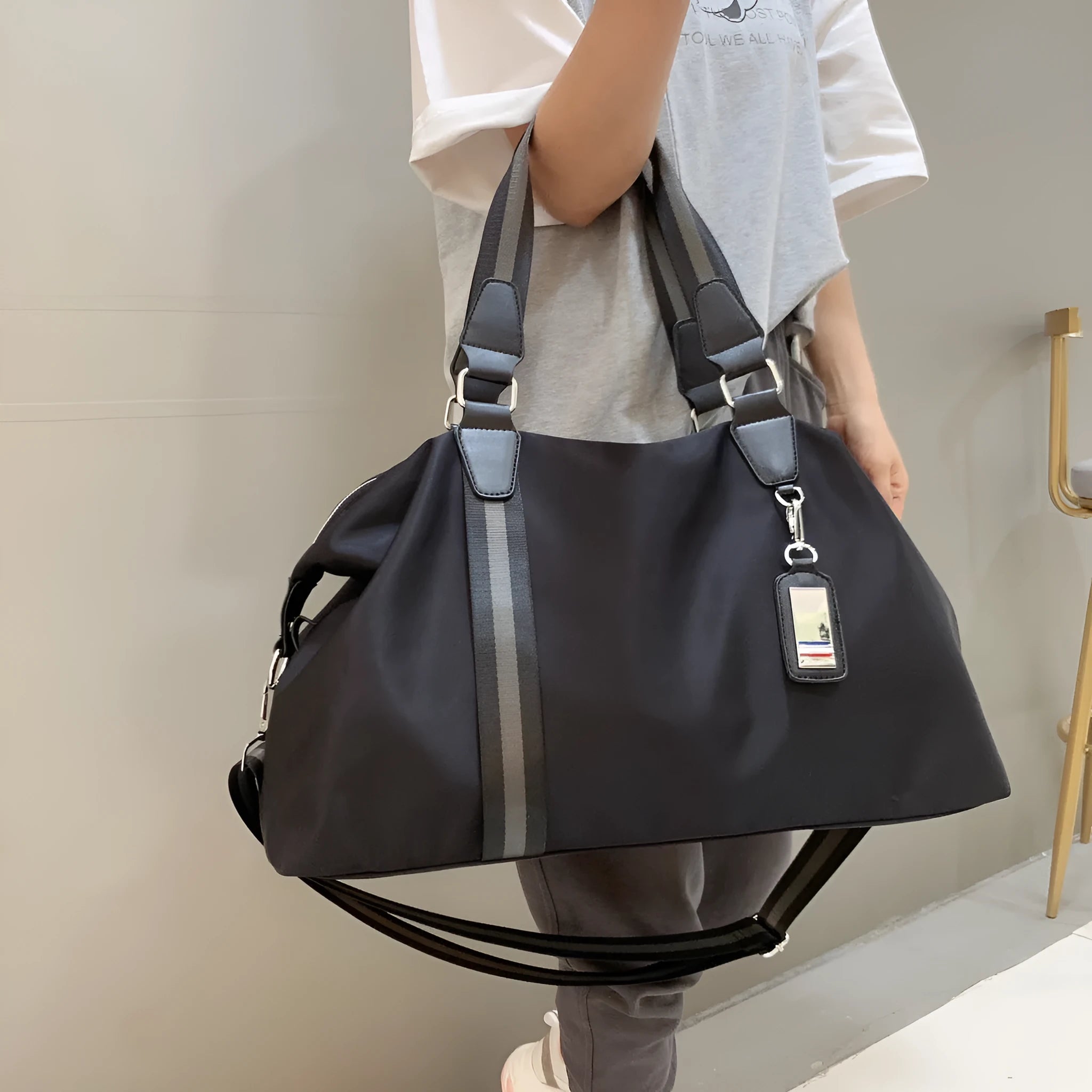 Men's black gold Oxford cloth travel bag with zipper opening and three shoulder straps shown on a neutral background
