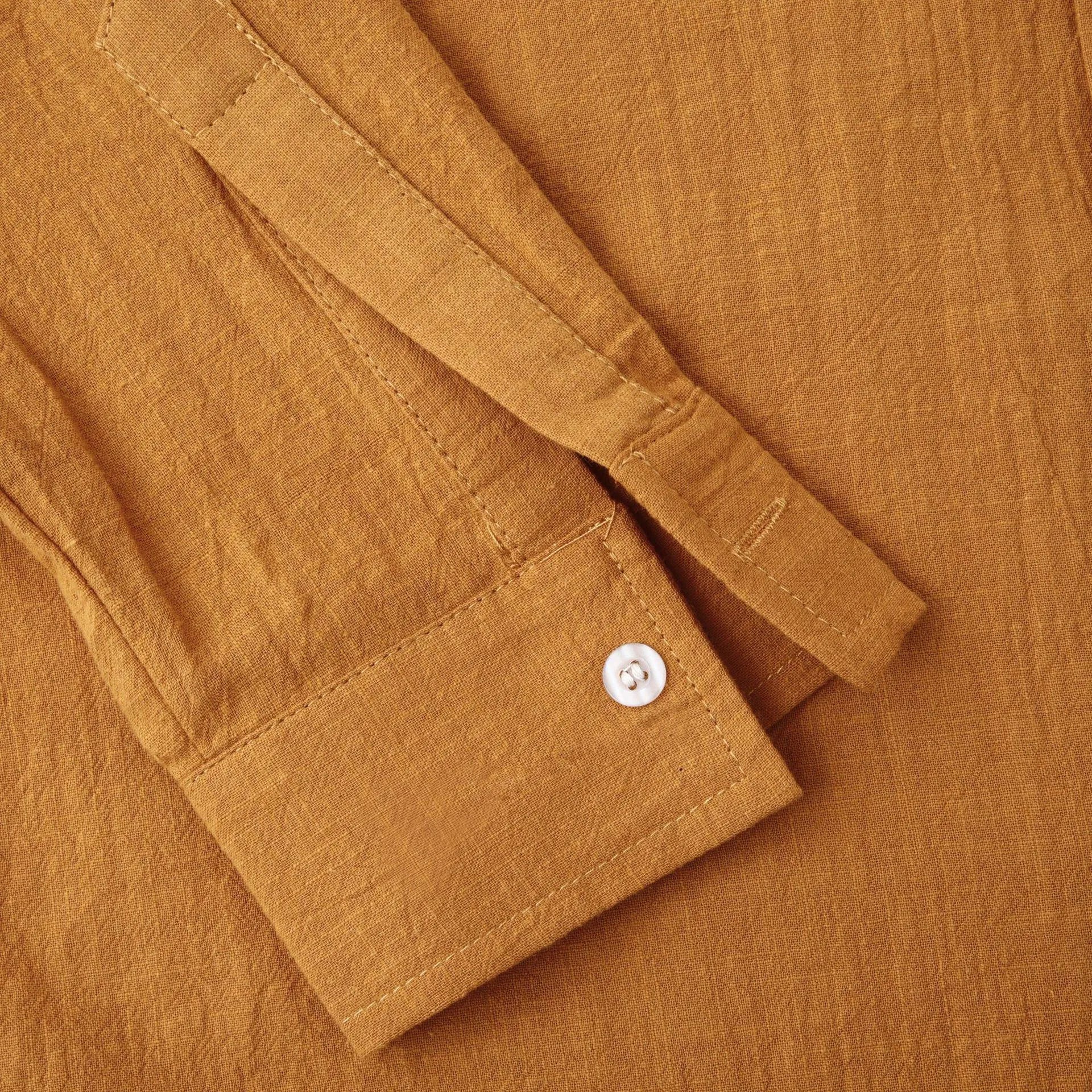 Men's slim fit brown cotton blend long sleeve shirt and matching casual trousers laid flat.