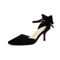 Black suede pointed-toe stiletto high heels with a bowknot detail and buckle ankle strap.