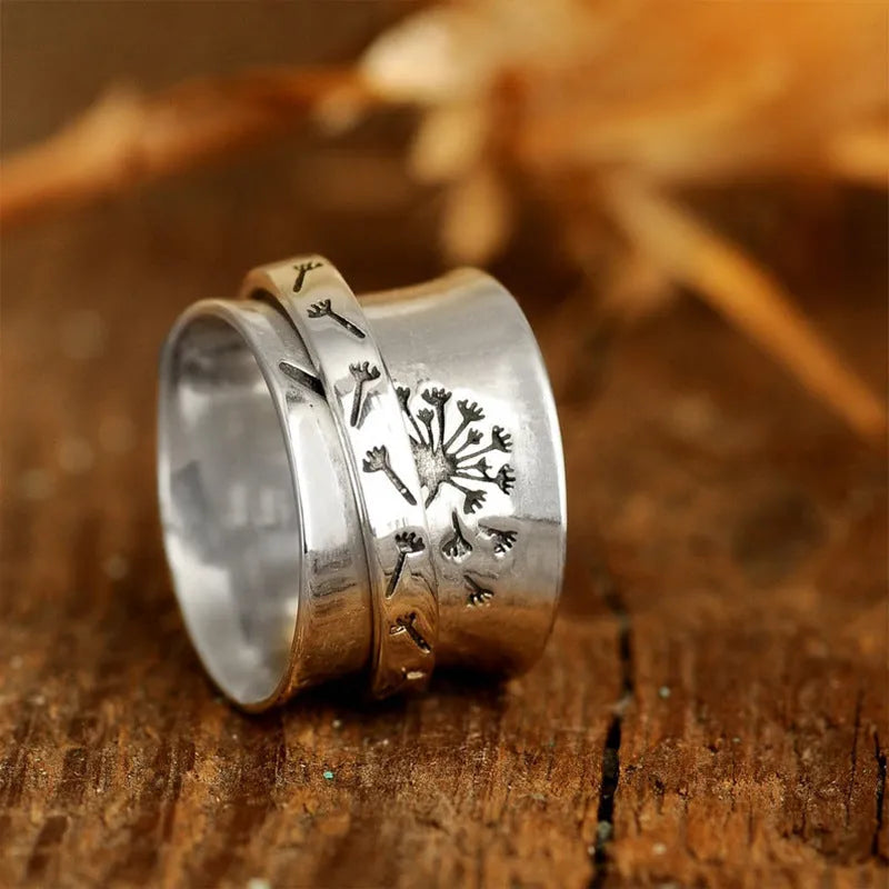 Silver rotatable flower ring showing petal detail and band, displayed with sizing options 7 through 11
