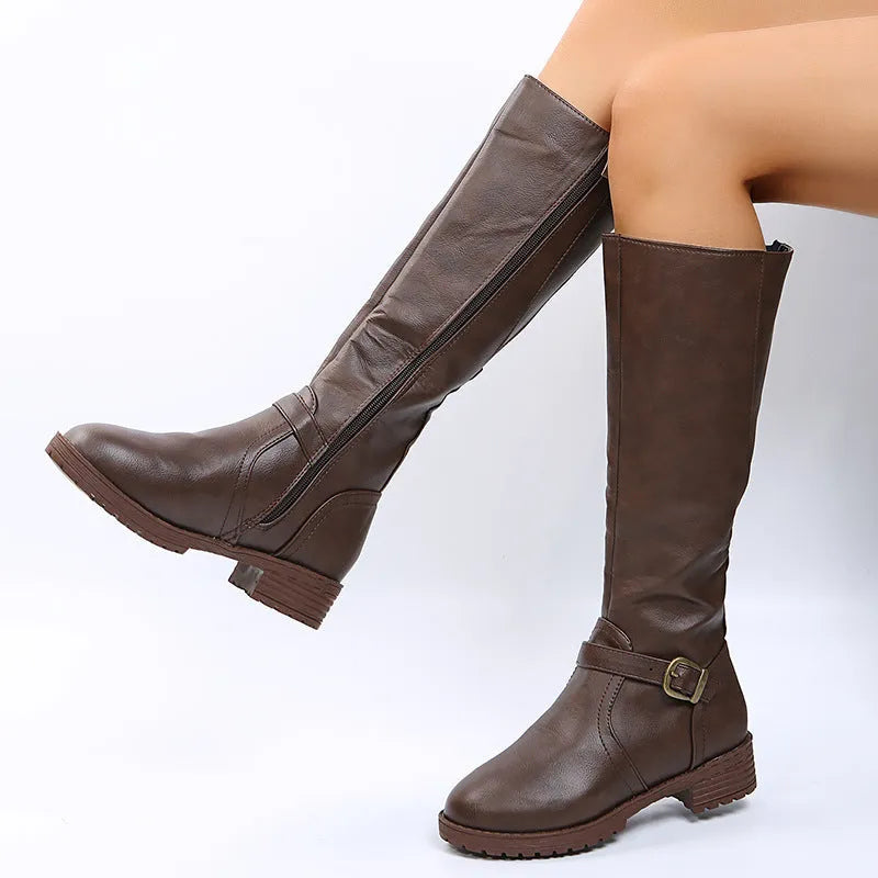 Women's solid colour knight boot with buckle detail, round toe, and square rubber heel.