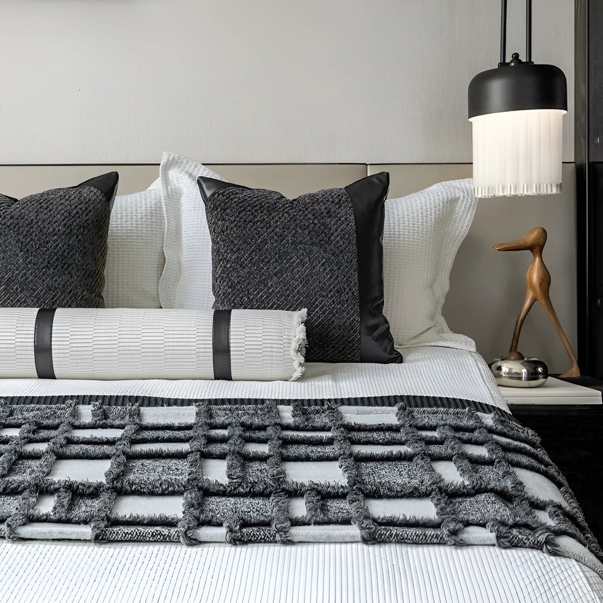 Grey and white plaid polyester bed runner nap blanket set with pillow on a bed.