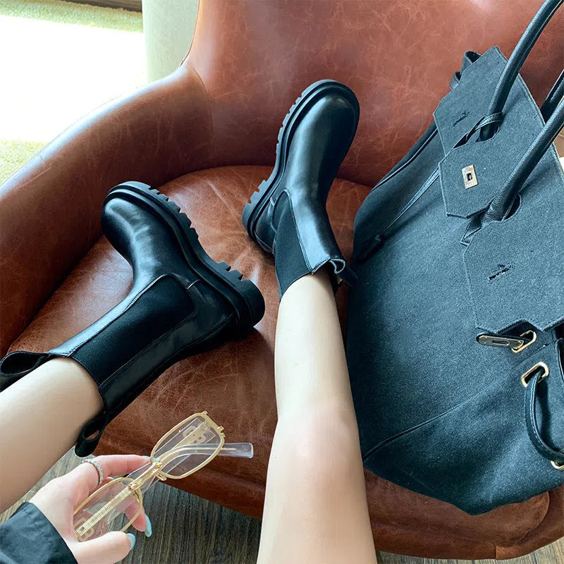 Women's black mid-calf boots with chunky low heel, round toe, and wear-resistant rubber sole in British style