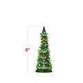 A resin Christmas tree-shaped lamp ornament with LED lights, shown in different sizes on a table.