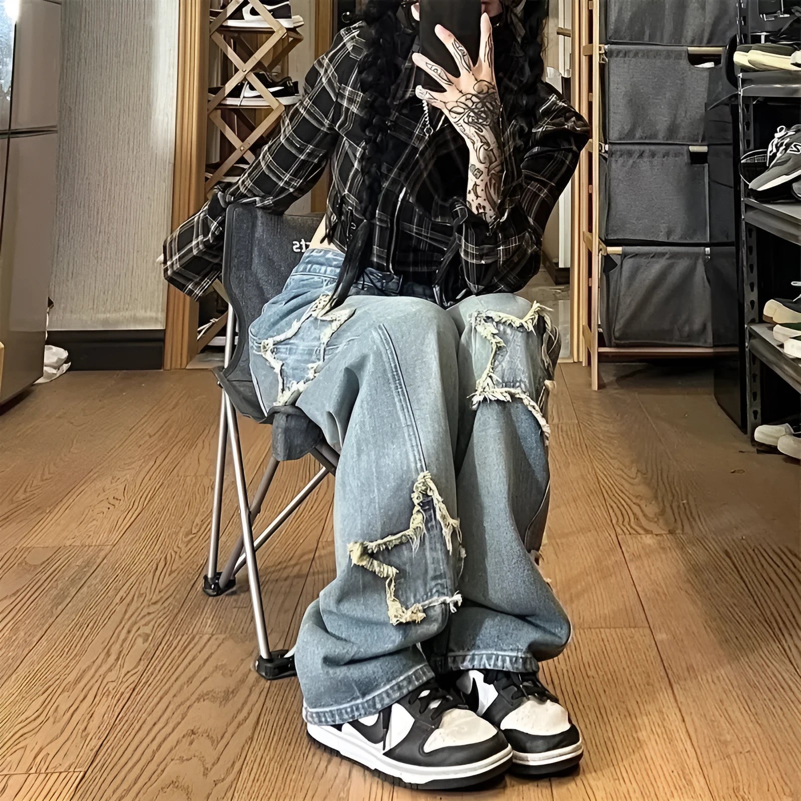 Blue high-waisted wide-leg denim pants with straight-leg silhouette on hanger
