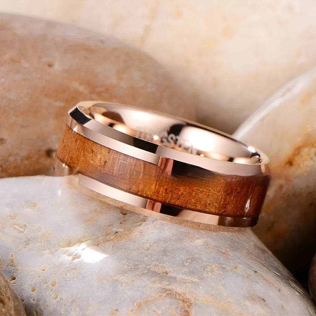 Men's 8mm wide U-shaped tungsten ring in rose gold finish on a hand.