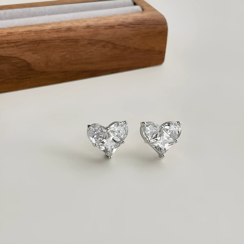 Pair of 925 sterling silver heart-shaped stud earrings with zircon detail and electroplated finish