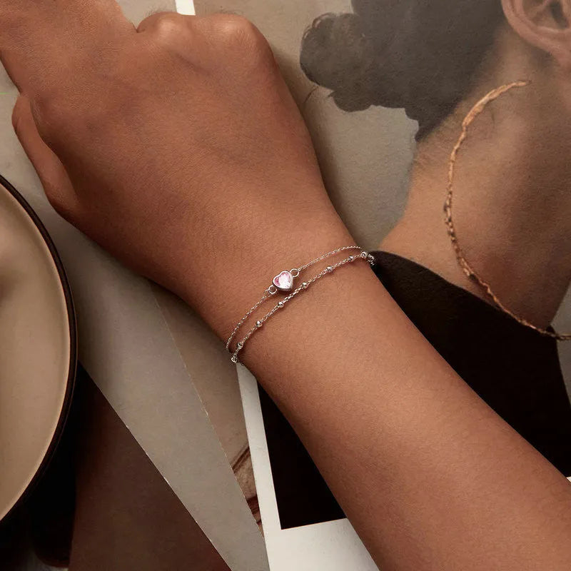 Sweet girlish 925 sterling silver bracelet with small heart-shaped pendant on an adjustable chain.
