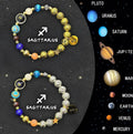 Two natural stone bead bracelets with zodiac symbols and adjustable knots in a gift box.