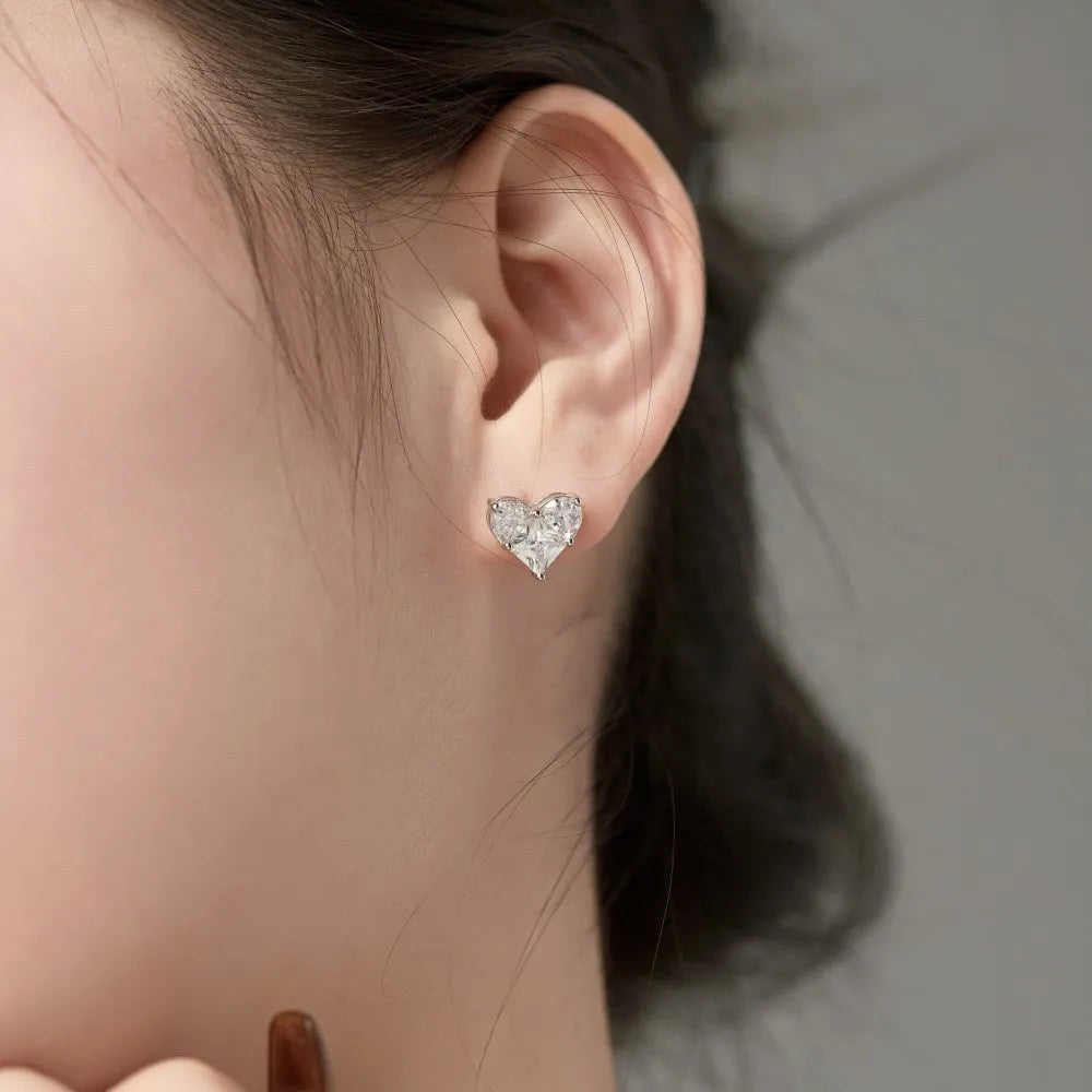 Pair of 925 sterling silver heart-shaped stud earrings with zircon detail and electroplated finish