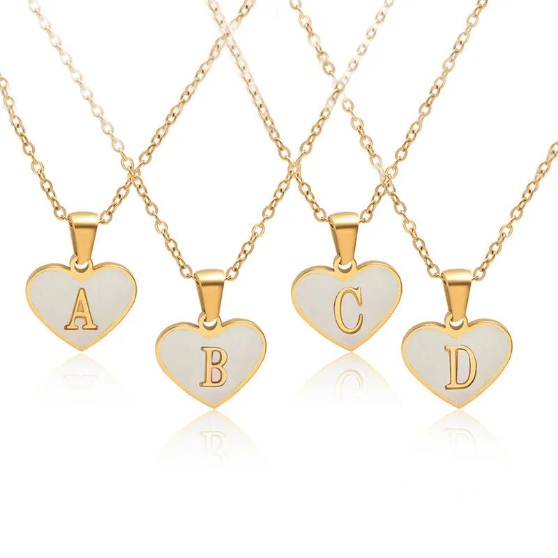 Personalised white shell heart necklace with gold chain and initial letter engraving