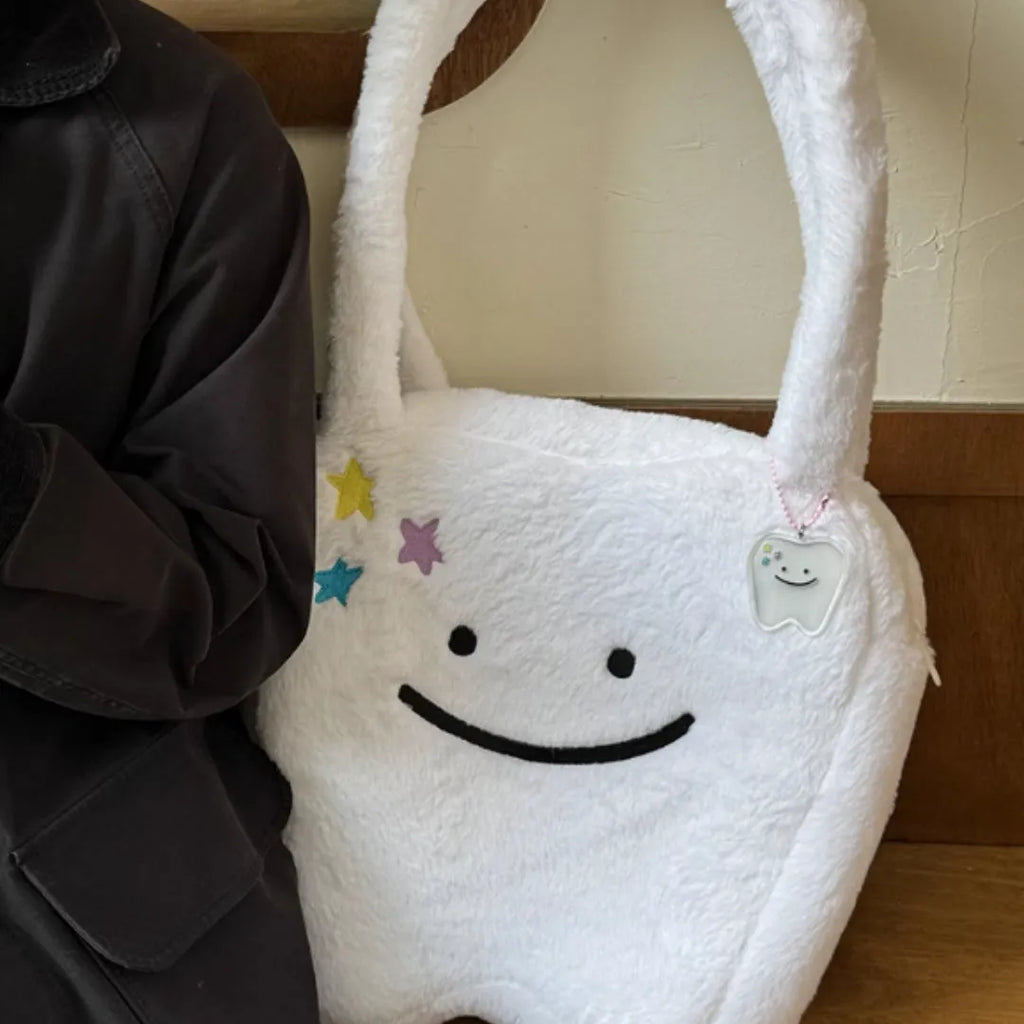 White plush tote bag with cute tooth pattern, zipper closure, and shoulder strap