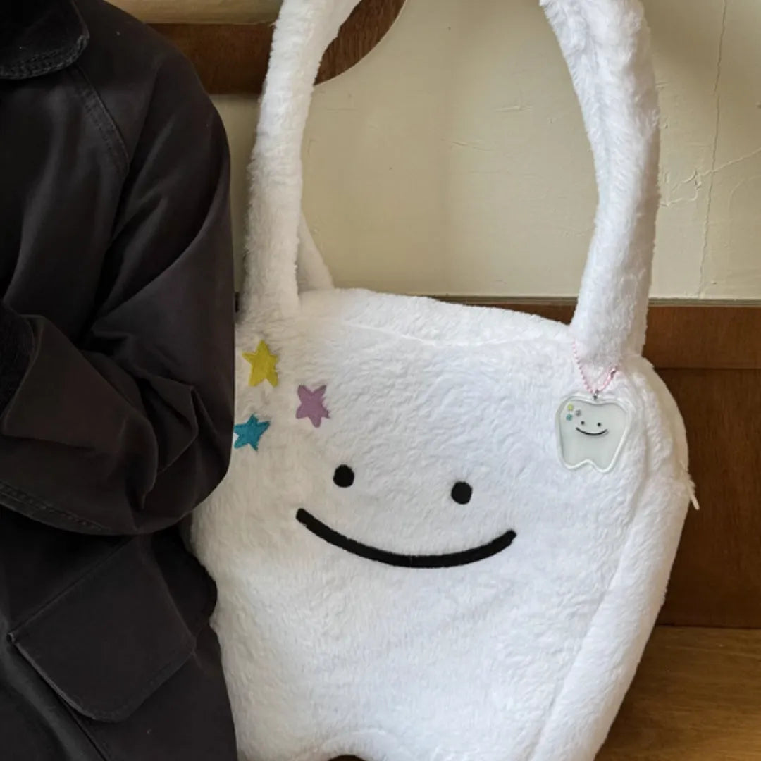 White plush tote bag with cute tooth pattern, zipper closure, and shoulder strap