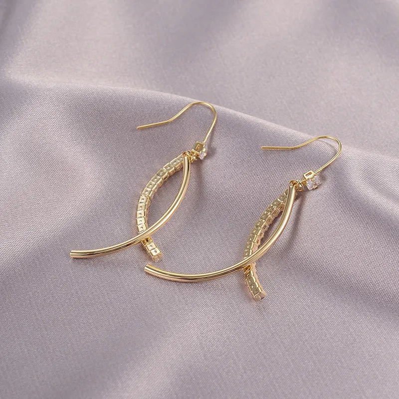 Pair of gold irregular geometric copper earrings on display