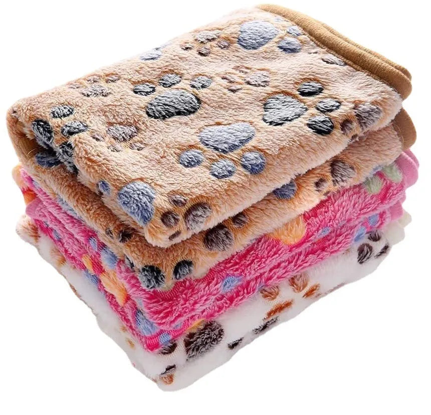 Coral fleece pet blanket with dog paw print pattern in beige, shown alongside size options from small to extra large.