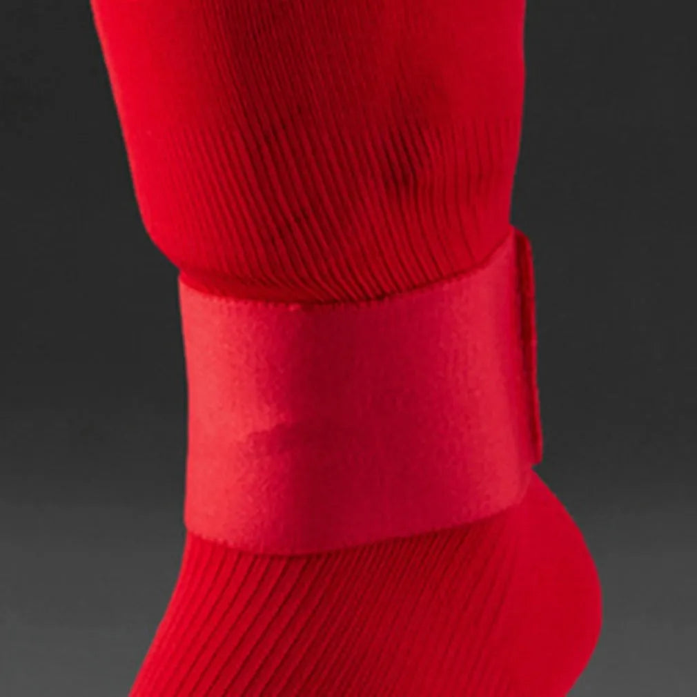 Red rubber football shin guard strap laid flat showing its 25cm length and 6.5cm width.