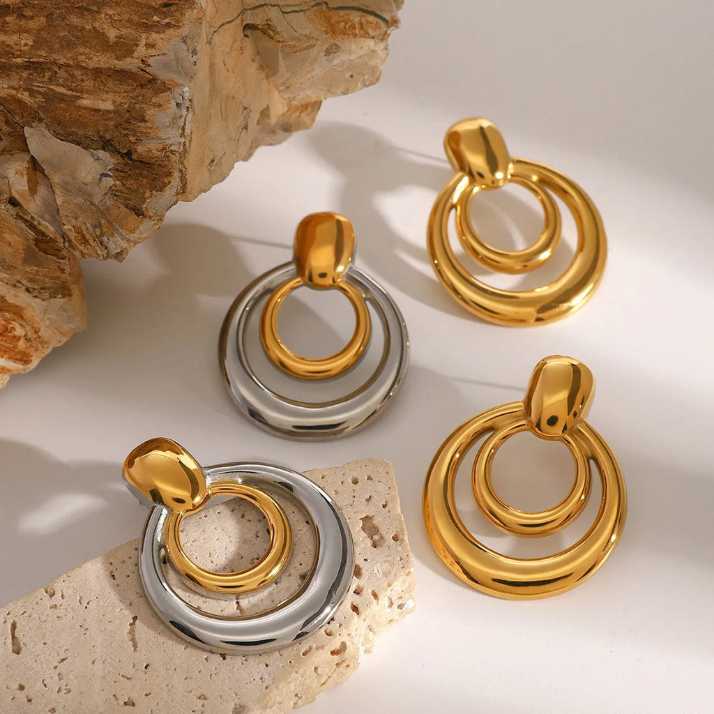 Golden electroplated titanium steel hollow geometric stud earrings showing double layer round design