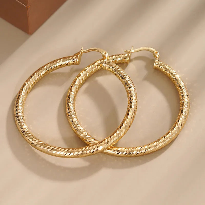 Women's geometric ring design ear clips in copper with electroplated finish showing drop-shaped silhouette