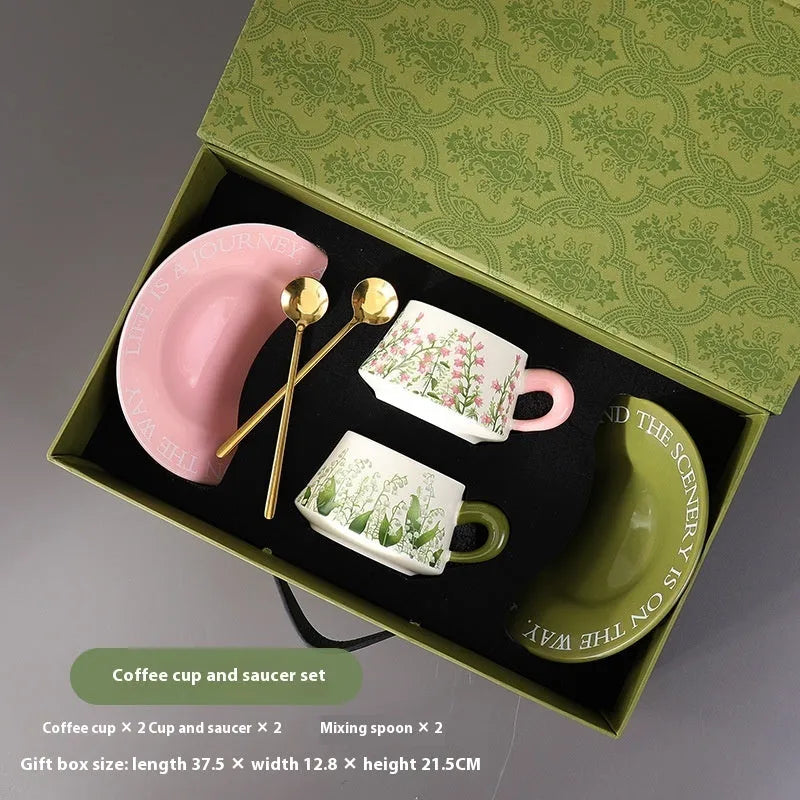 Ceramic coffee cup and saucer set with two cups, two plates, and two spoons in Campanula design