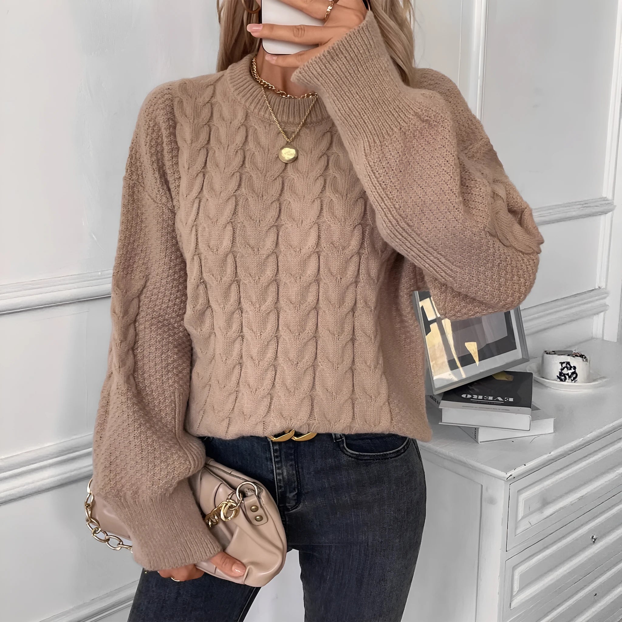 Women's loose beige round neck pullover sweater on a hanger.