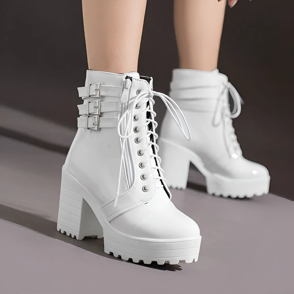 Women's black ankle boot with a thick rubber heel, round toe, and front lace-up closure on a waterproof platform.