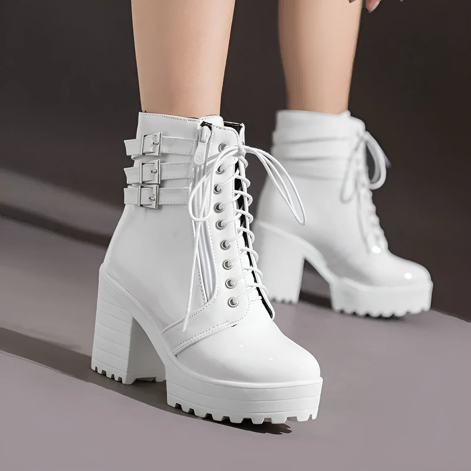 Women's black ankle boot with a thick rubber heel, round toe, and front lace-up closure on a waterproof platform.