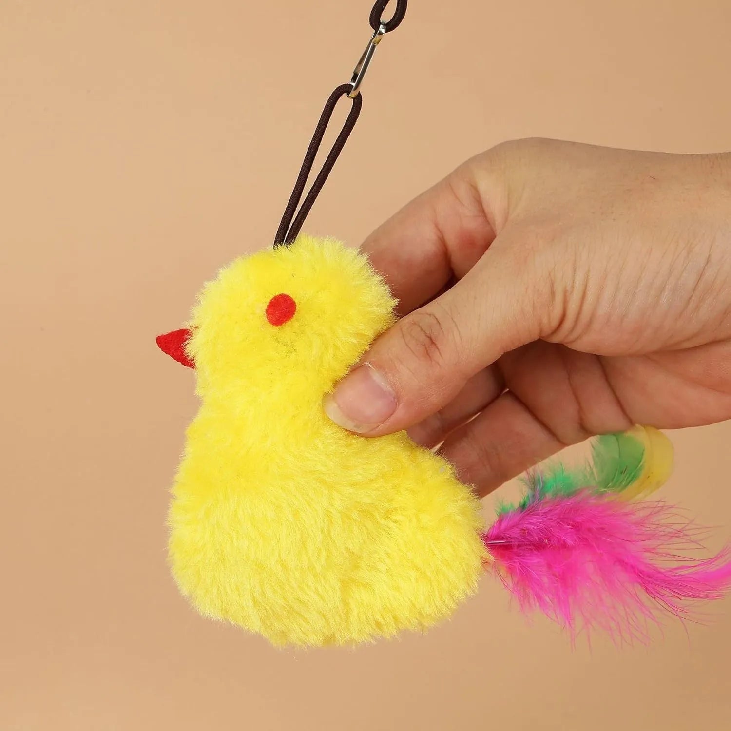 Grey interactive cat toy hanging from door frame with retractable elastic rope, treat dispenser bulb, and dangling mouse attachment