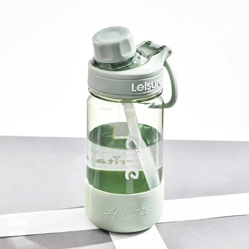 Plastic drinking cup with cartoon pattern in grey, green and pink colours showing three capacity options