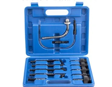 13-piece automatic transmission oil refuelling kit with injector tool and connector attachments on a bench.