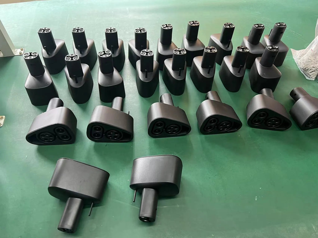 Black Tesla charging plug conversion adapter showing connector interfaces and housing