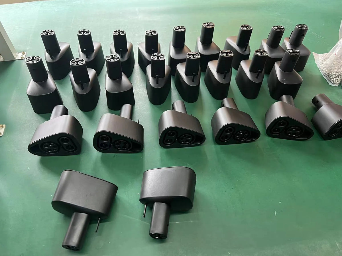 Black Tesla charging plug conversion adapter showing connector interfaces and housing