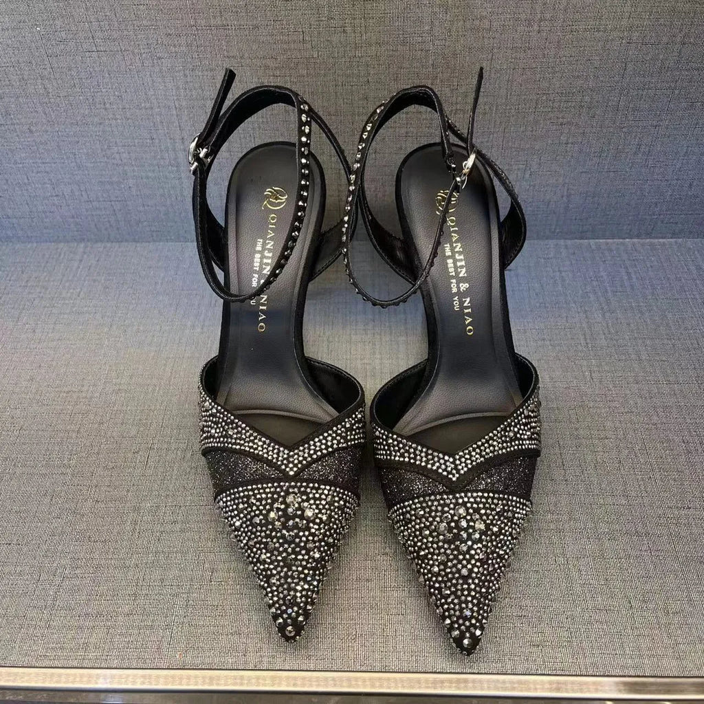 Women's black hollow stiletto heel pumps with a red sole and pointed toe.