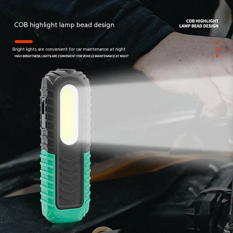 Black and green auto repair work light with USB charging cable for vehicle inspections