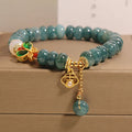 Women's blue water jade abacus bead bracelet with alloy charms, white agate, and rhinestone details