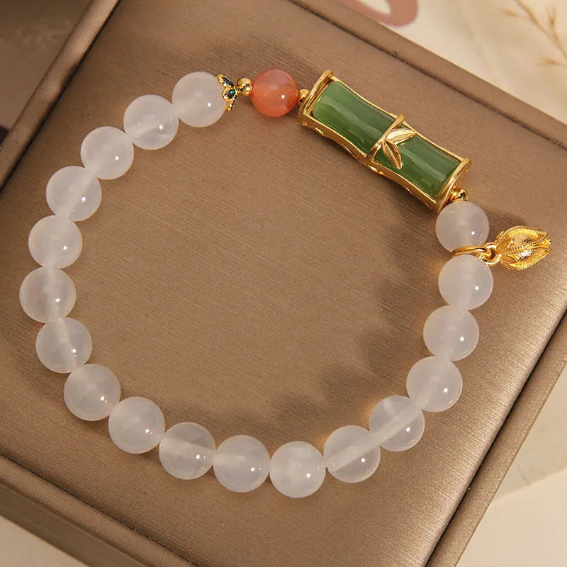Close-up of a white agate and jade bamboo joint bracelet for women, traditional Chinese style.
