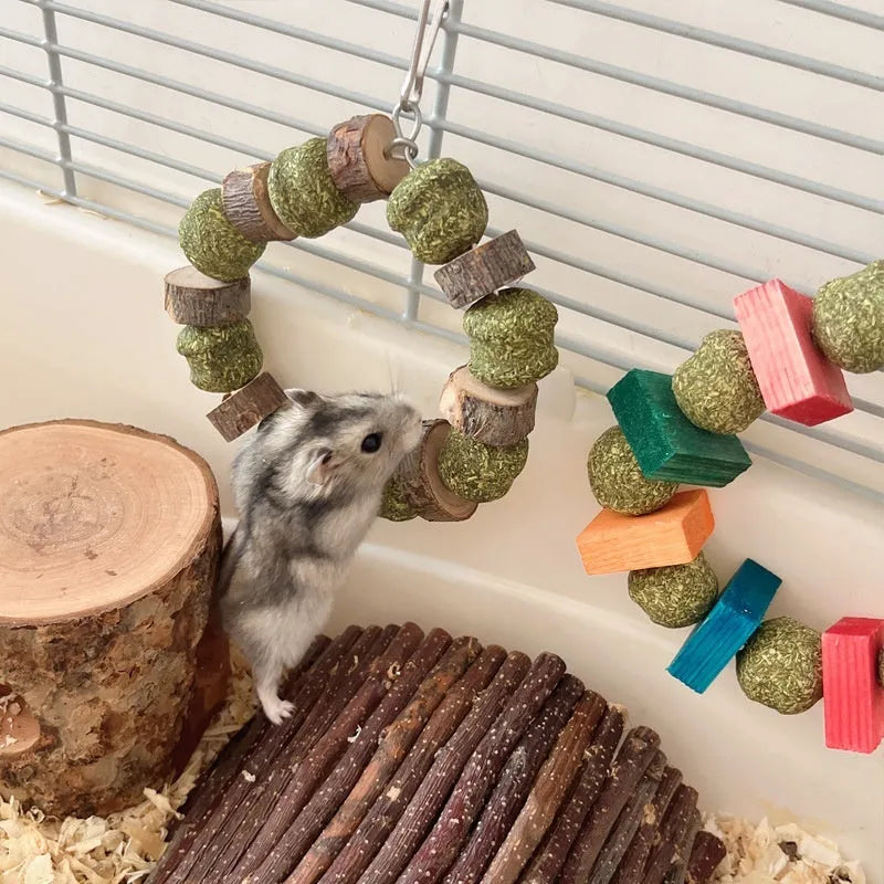 Hamster chew toy featuring an applewood rod with an attached woven straw ball ring.