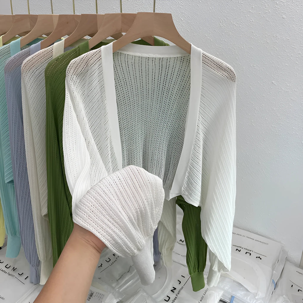 Women's apricot coloured blouse with long loose lantern sleeves and a hollow linen-look weave.