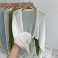 Women's apricot coloured blouse with long loose lantern sleeves and a hollow linen-look weave.