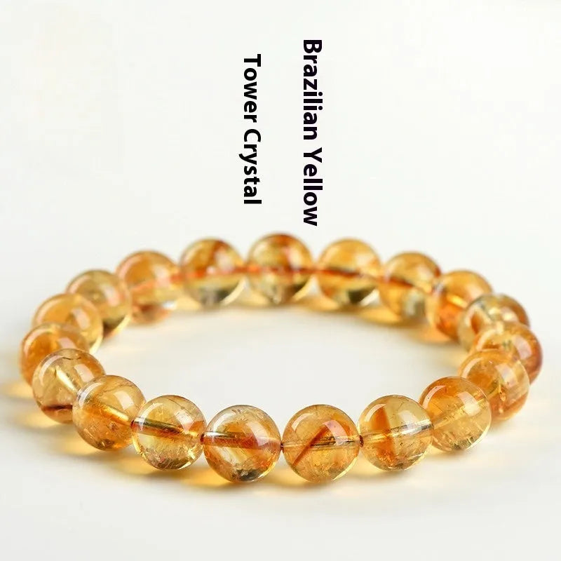 Natural yellow citrine gemstone bracelet with geometric beads on a white background.