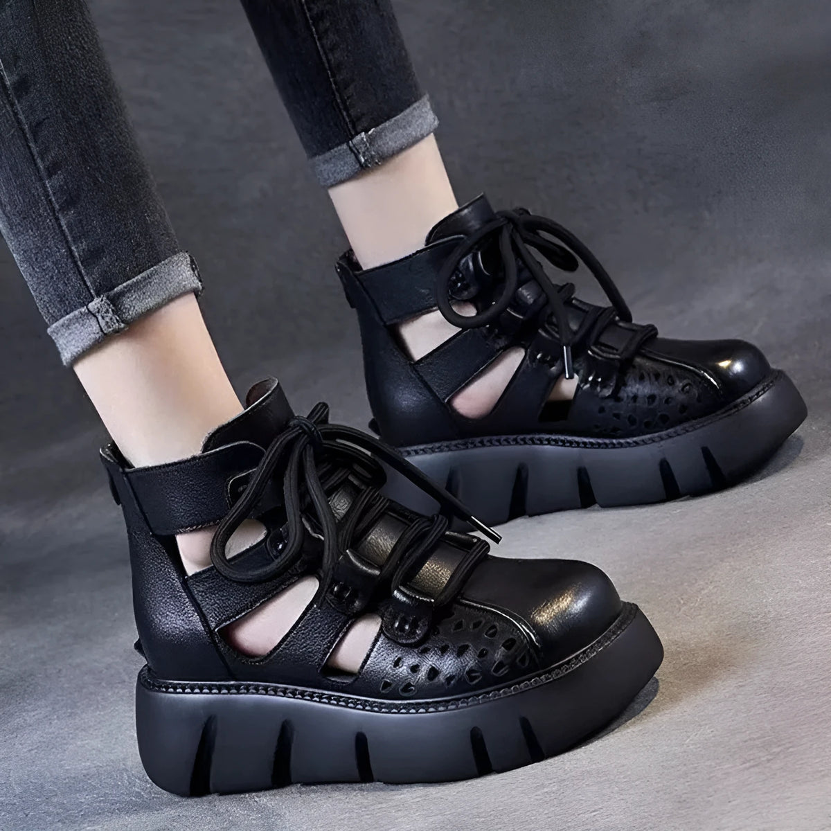 Women's black platform sandals with fish mouth toe and plush leather upper on a neutral background.
