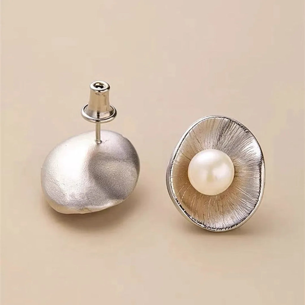 Pearl sterling silver needle earrings with gold electroplated finish and geometric design