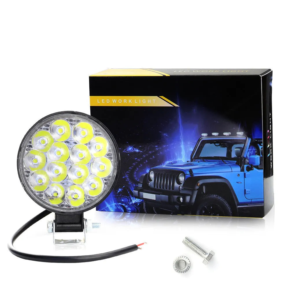 Round mini aluminium LED work light showing white light beam, suitable for vehicle mounting.