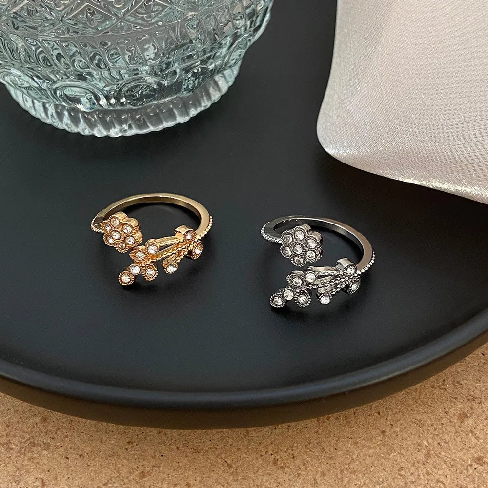 Women's copper open ring with a diamond-faceted flower and leaf design in gold and white colour options.