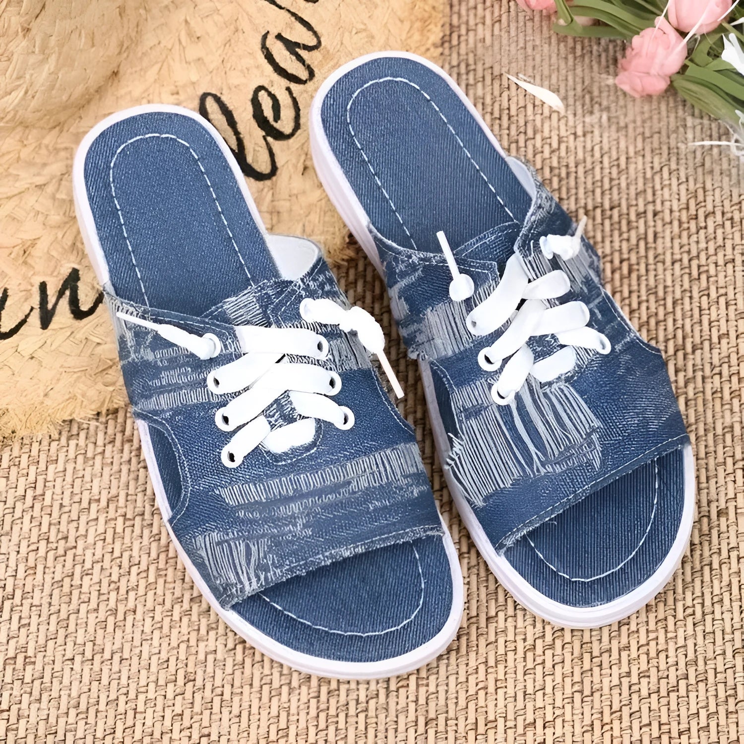 Blue Roman style women's canvas slippers with cloth upper and rubber sole.